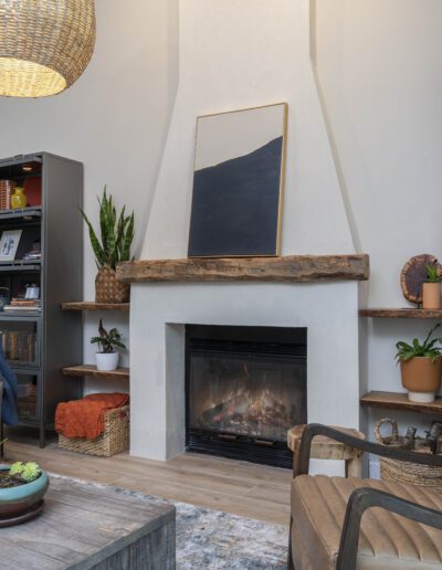 Cozy living room interior with a fireplace and modern decor.