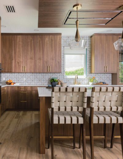 Modern kitchen interior with wooden cabinetry and a dining area.