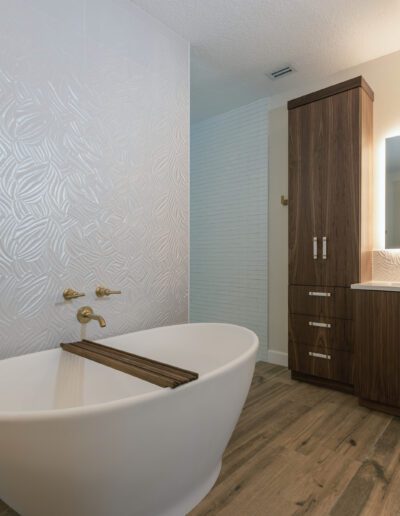 Modern bathroom with a freestanding bathtub and wooden cabinetry.